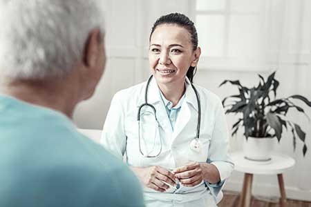 A doctor talks to an elderly patient about what conditions qualify for social security disability benefits.
