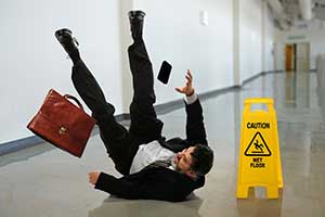 Person falling and needing a slip and fall lawyer. 